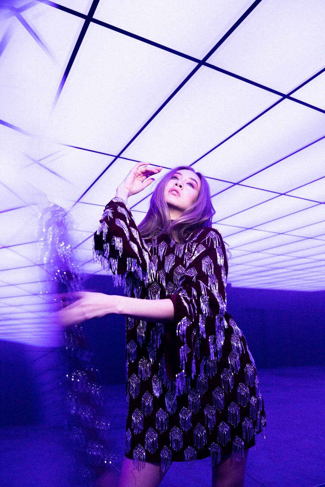 Editorial fashion runway moment with dramatic lighting and flowing garments